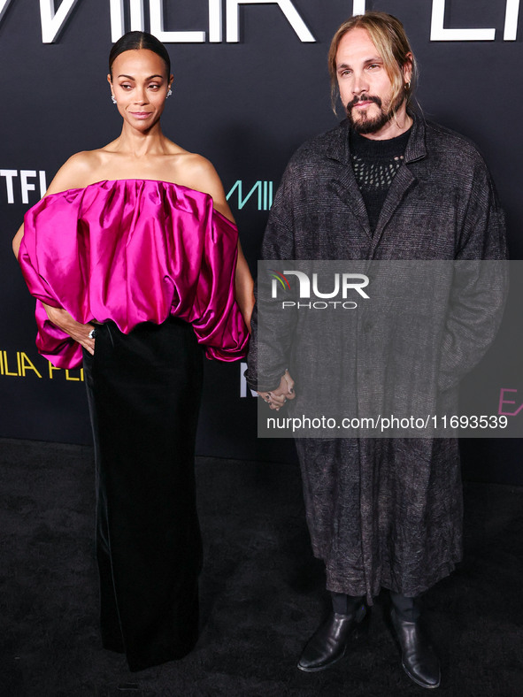 Zoe Saldana and husband Marco Perego-Saldana arrive at the Los Angeles Premiere of Netflix's 'Emilia Perez' held at The Egyptian Theatre Hol...