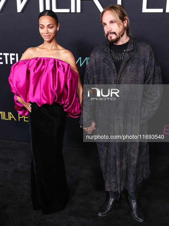 Zoe Saldana and husband Marco Perego-Saldana arrive at the Los Angeles Premiere of Netflix's 'Emilia Perez' held at The Egyptian Theatre Hol...