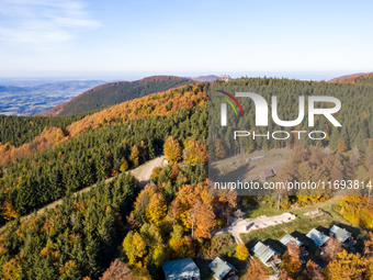 Aerial View of Moravian-Silesian Beskids mountain range as autumn trees shine with colours in Czech Republic on October 20, 2024. The range...