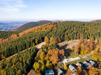 Aerial View of Moravian-Silesian Beskids mountain range as autumn trees shine with colours in Czech Republic on October 20, 2024. The range...