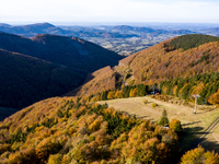 Aerial View of Moravian-Silesian Beskids mountain range as autumn trees shine with colours in Czech Republic on October 20, 2024. The range...