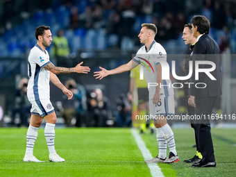 Hakan Calhanoglu of FC Internazionale leaves the pitch injured during the Serie A Enilive match between AS Roma and FC Internazionale at Sta...