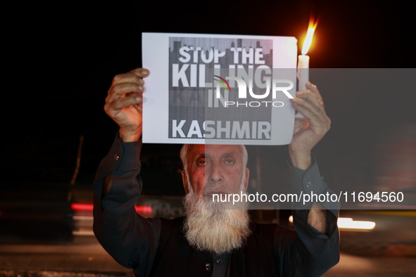 Religious leaders, young boys, and political leaders hold placards and Indian national flags as they protest against the killings of Gagange...