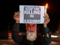 Religious leaders, young boys, and political leaders hold placards and Indian national flags as they protest against the killings of Gagange...