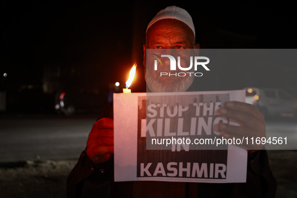 Religious leaders, young boys, and political leaders hold placards and Indian national flags as they protest against the killings of Gagange...