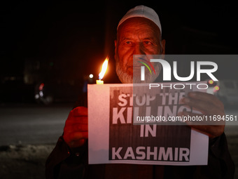 Religious leaders, young boys, and political leaders hold placards and Indian national flags as they protest against the killings of Gagange...