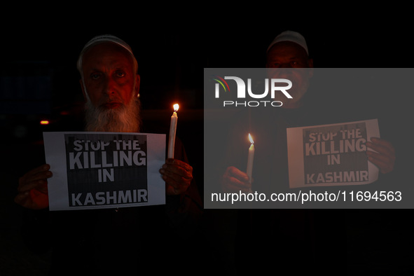 Religious leaders, young boys, and political leaders hold placards and Indian national flags as they protest against the killings of Gagange...