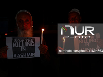 Religious leaders, young boys, and political leaders hold placards and Indian national flags as they protest against the killings of Gagange...