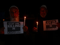 Religious leaders, young boys, and political leaders hold placards and Indian national flags as they protest against the killings of Gagange...