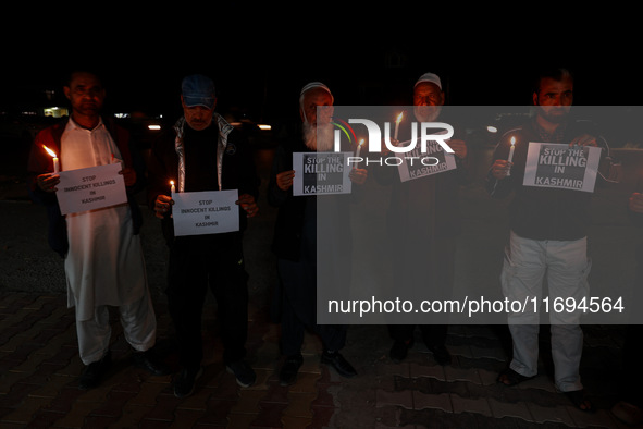 Religious leaders, young boys, and political leaders hold placards and Indian national flags as they protest against the killings of Gagange...