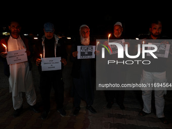 Religious leaders, young boys, and political leaders hold placards and Indian national flags as they protest against the killings of Gagange...