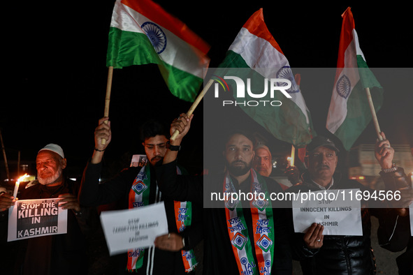 Religious leaders, young boys, and political leaders hold placards and Indian national flags as they protest against the killings of Gagange...