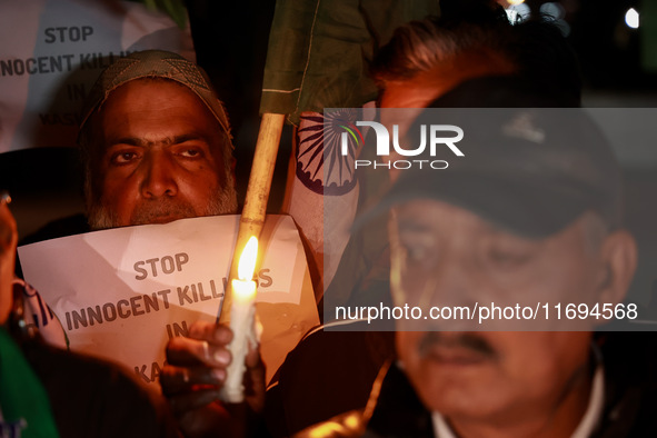 Religious leaders, young boys, and political leaders hold placards and Indian national flags as they protest against the killings of Gagange...