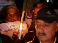 Religious leaders, young boys, and political leaders hold placards and Indian national flags as they protest against the killings of Gagange...