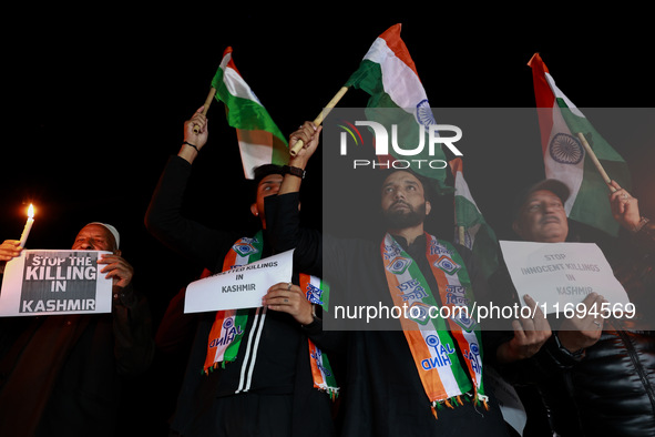 Religious leaders, young boys, and political leaders hold placards and Indian national flags as they protest against the killings of Gagange...