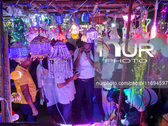 People buy decorative lights ahead of the Diwali festival celebration in Kolkata, India, on October 22, 2024. (