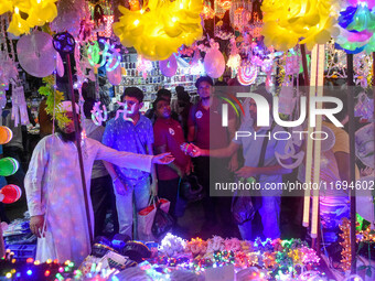 People buy decorative lights ahead of the Diwali festival celebration in Kolkata, India, on October 22, 2024. (