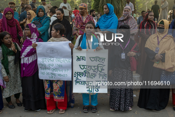 Protesters from the Domestic Workers' National Forum form a human chain at the Shaheed Minar in Dhaka, Bangladesh, on October 22, 2024, dema...