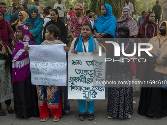 Protesters from the Domestic Workers' National Forum form a human chain at the Shaheed Minar in Dhaka, Bangladesh, on October 22, 2024, dema...