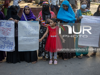 Protesters from the Domestic Workers' National Forum form a human chain at the Shaheed Minar in Dhaka, Bangladesh, on October 22, 2024, dema...