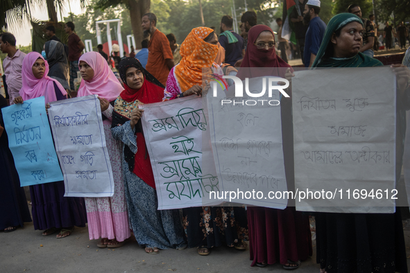 Protesters from the Domestic Workers' National Forum form a human chain at the Shaheed Minar in Dhaka, Bangladesh, on October 22, 2024, dema...