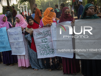 Protesters from the Domestic Workers' National Forum form a human chain at the Shaheed Minar in Dhaka, Bangladesh, on October 22, 2024, dema...