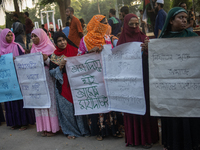 Protesters from the Domestic Workers' National Forum form a human chain at the Shaheed Minar in Dhaka, Bangladesh, on October 22, 2024, dema...