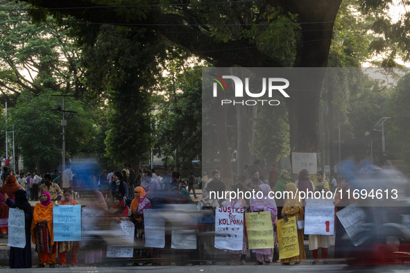 Protesters from the Domestic Workers' National Forum form a human chain at the Shaheed Minar in Dhaka, Bangladesh, on October 22, 2024, dema...