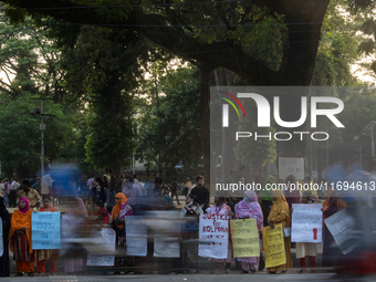 Protesters from the Domestic Workers' National Forum form a human chain at the Shaheed Minar in Dhaka, Bangladesh, on October 22, 2024, dema...