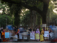 Protesters from the Domestic Workers' National Forum form a human chain at the Shaheed Minar in Dhaka, Bangladesh, on October 22, 2024, dema...