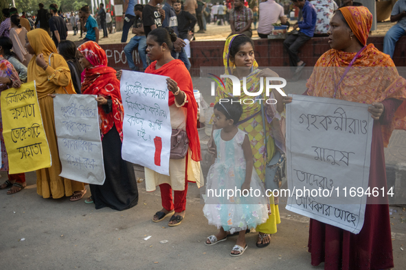 Protesters from the Domestic Workers' National Forum form a human chain at the Shaheed Minar in Dhaka, Bangladesh, on October 22, 2024, dema...