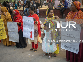 Protesters from the Domestic Workers' National Forum form a human chain at the Shaheed Minar in Dhaka, Bangladesh, on October 22, 2024, dema...