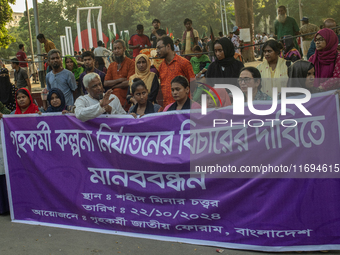 Protesters from the Domestic Workers' National Forum form a human chain at the Shaheed Minar in Dhaka, Bangladesh, on October 22, 2024, dema...