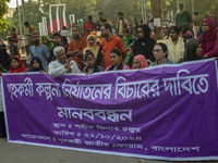 Protesters from the Domestic Workers' National Forum form a human chain at the Shaheed Minar in Dhaka, Bangladesh, on October 22, 2024, dema...