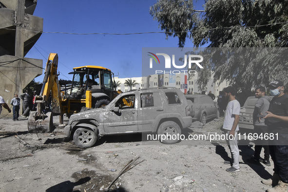 Civilians, paramedics, and Civil Defense Search and Rescue teams conduct search and rescue operations among the rubble of collapsed building...