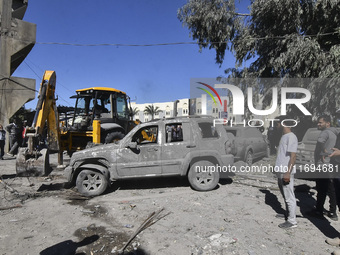 Civilians, paramedics, and Civil Defense Search and Rescue teams conduct search and rescue operations among the rubble of collapsed building...