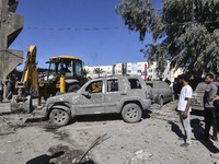 Civilians, paramedics, and Civil Defense Search and Rescue teams conduct search and rescue operations among the rubble of collapsed building...