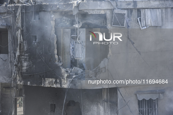 Civilians, paramedics, and Civil Defense Search and Rescue teams conduct search and rescue operations among the rubble of collapsed building...