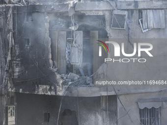 Civilians, paramedics, and Civil Defense Search and Rescue teams conduct search and rescue operations among the rubble of collapsed building...