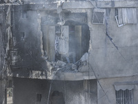 Civilians, paramedics, and Civil Defense Search and Rescue teams conduct search and rescue operations among the rubble of collapsed building...