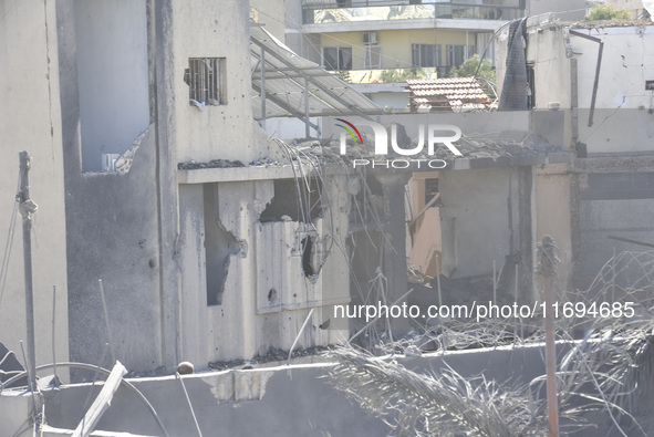 Civilians, paramedics, and Civil Defense Search and Rescue teams conduct search and rescue operations among the rubble of collapsed building...