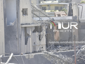 Civilians, paramedics, and Civil Defense Search and Rescue teams conduct search and rescue operations among the rubble of collapsed building...