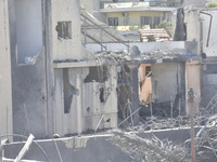 Civilians, paramedics, and Civil Defense Search and Rescue teams conduct search and rescue operations among the rubble of collapsed building...