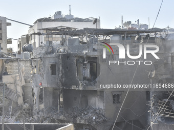 Civilians, paramedics, and Civil Defense Search and Rescue teams conduct search and rescue operations among the rubble of collapsed building...