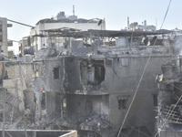 Civilians, paramedics, and Civil Defense Search and Rescue teams conduct search and rescue operations among the rubble of collapsed building...