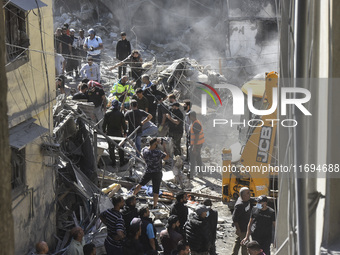 Civilians, paramedics, and Civil Defense Search and Rescue teams conduct search and rescue operations among the rubble of collapsed building...