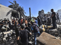 Civilians, paramedics, and Civil Defense Search and Rescue teams conduct search and rescue operations among the rubble of collapsed building...