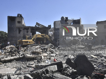 Civilians, paramedics, and Civil Defense Search and Rescue teams conduct search and rescue operations among the rubble of collapsed building...