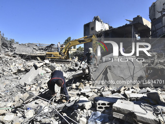 Civilians, paramedics, and Civil Defense Search and Rescue teams conduct search and rescue operations among the rubble of collapsed building...