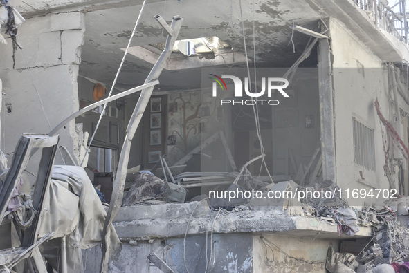 Civilians, paramedics, and Civil Defense Search and Rescue teams conduct search and rescue operations among the rubble of collapsed building...